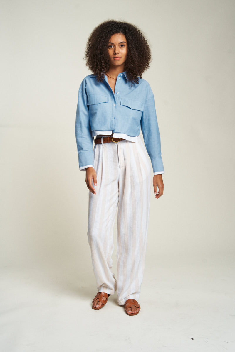 Woman wearing lightweight high-waisted dress pants with a white shirt. The perfect balance of comfort and style.
