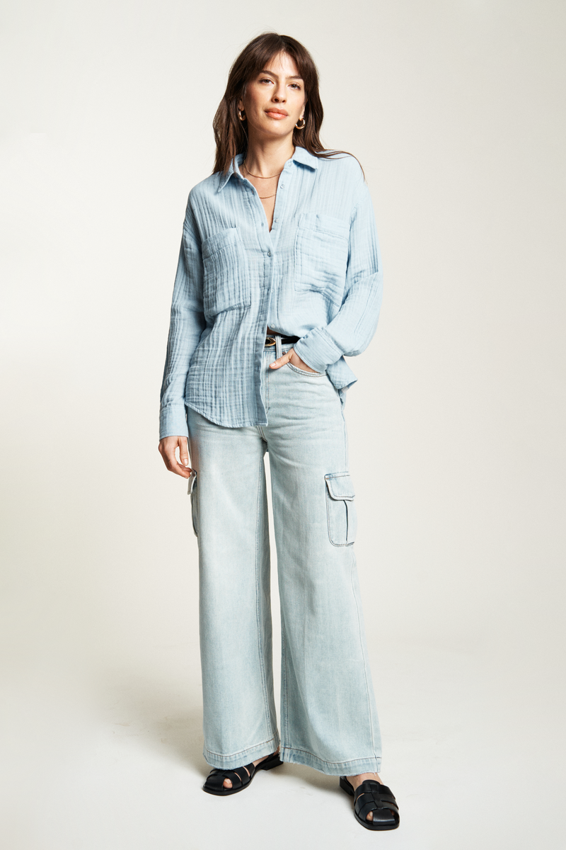 blue button-up top in a soft, lightweight fabric, styled with blue jeans for a relaxed, everyday look