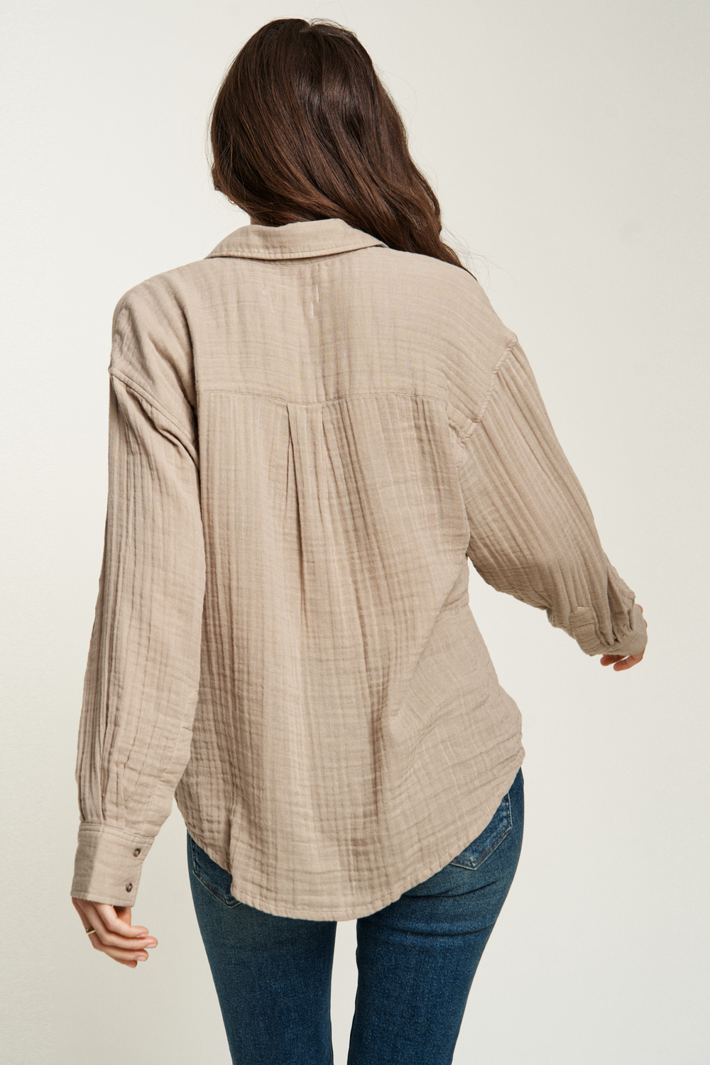 Women's long-sleeve button-up top in a textured, breathable fabric, perfect for casual layering with jeans.