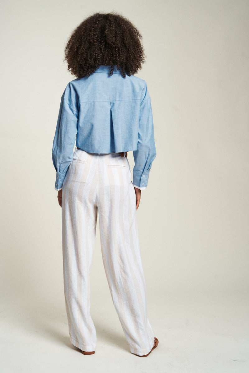 Rear view of lightweight dress pants in a relaxed fit. Paired with a crisp white shirt, ideal for professional settings.