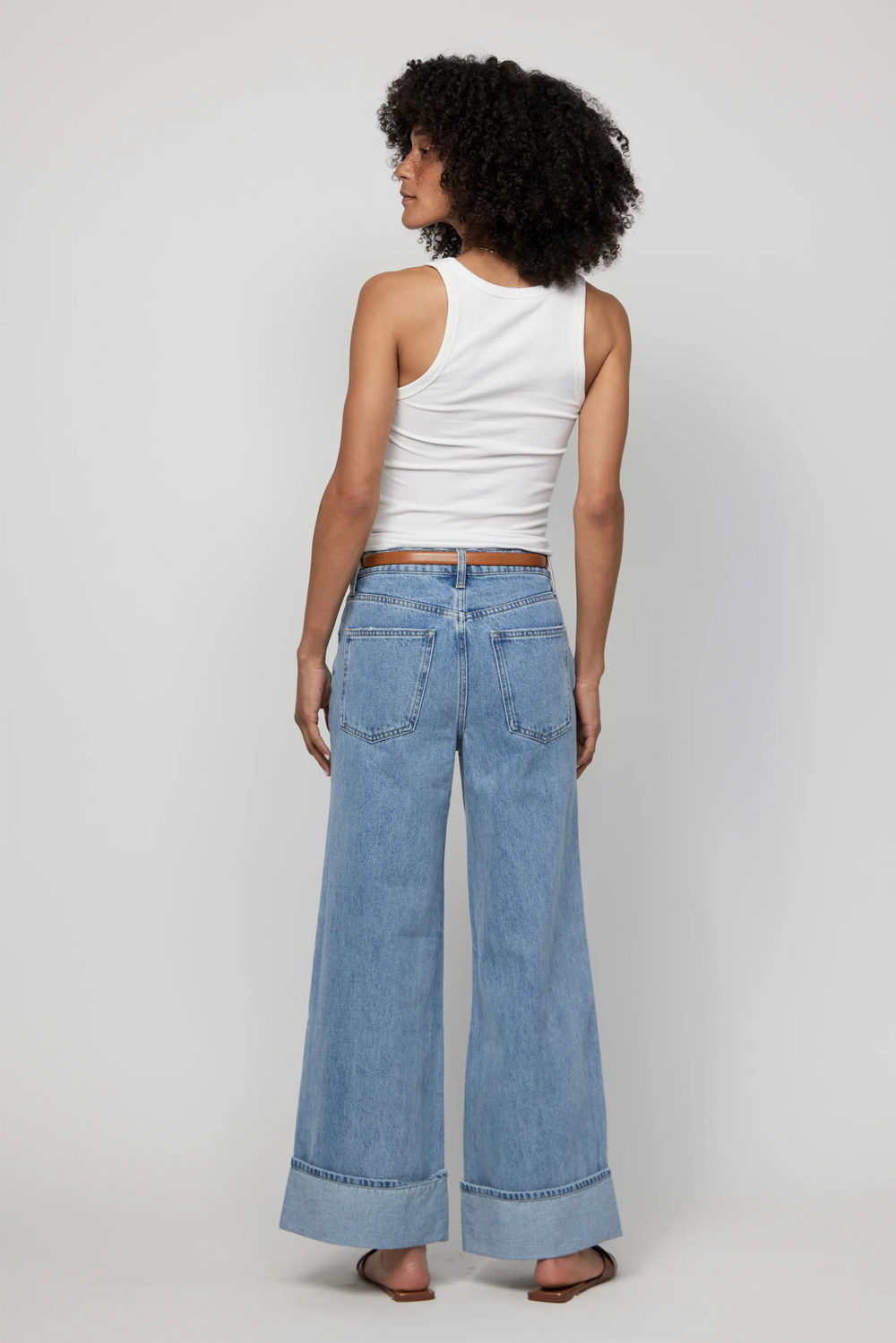 Back view of mid-rise wide-leg jeans with deep cuffs in a relaxed light wash.