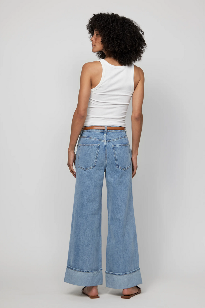 Back view of mid-rise wide-leg jeans with deep cuffs in a relaxed light wash.