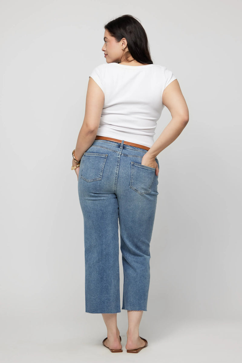 Back view of plus-size cropped denim jeans for women, featuring a flattering high-rise and relaxed fit.