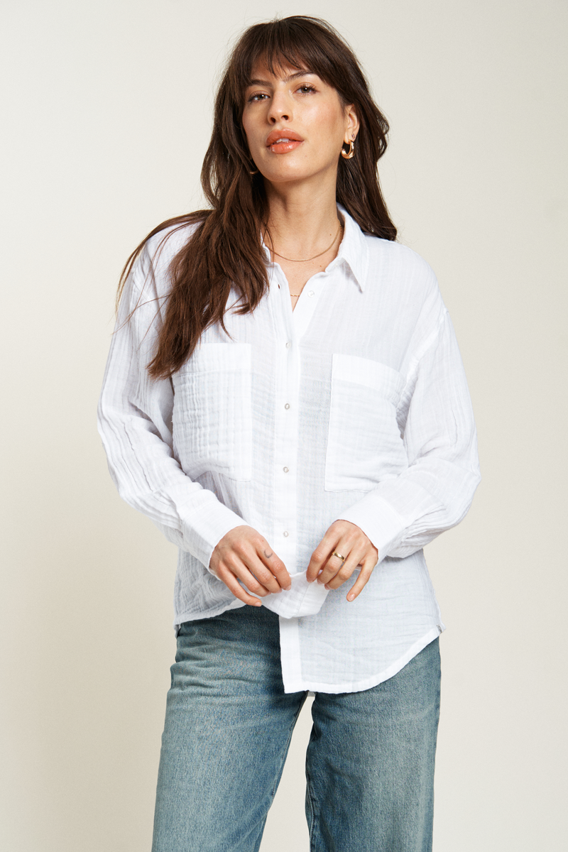 Breezy button-up top for women, styled with rolled sleeves and light denim, ideal for warm-weather outfits.