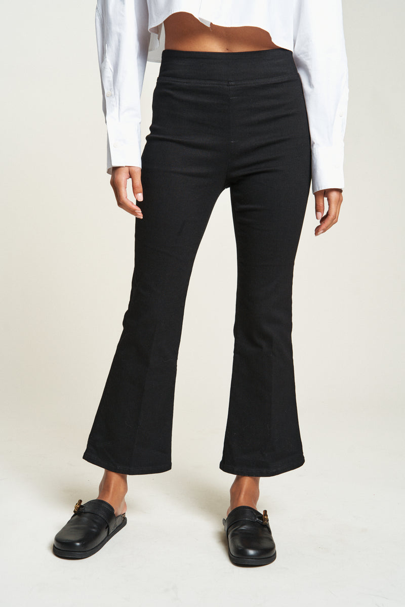 Close-up of cropped flare pull-on pants waistband and hem, showcasing smooth fit and stretchy fabric.