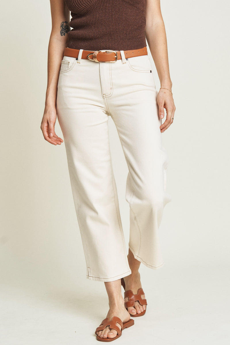 Close-up of ecru wide-leg ankle crop jeans, emphasizing the durable fabric and soft neutral tone.