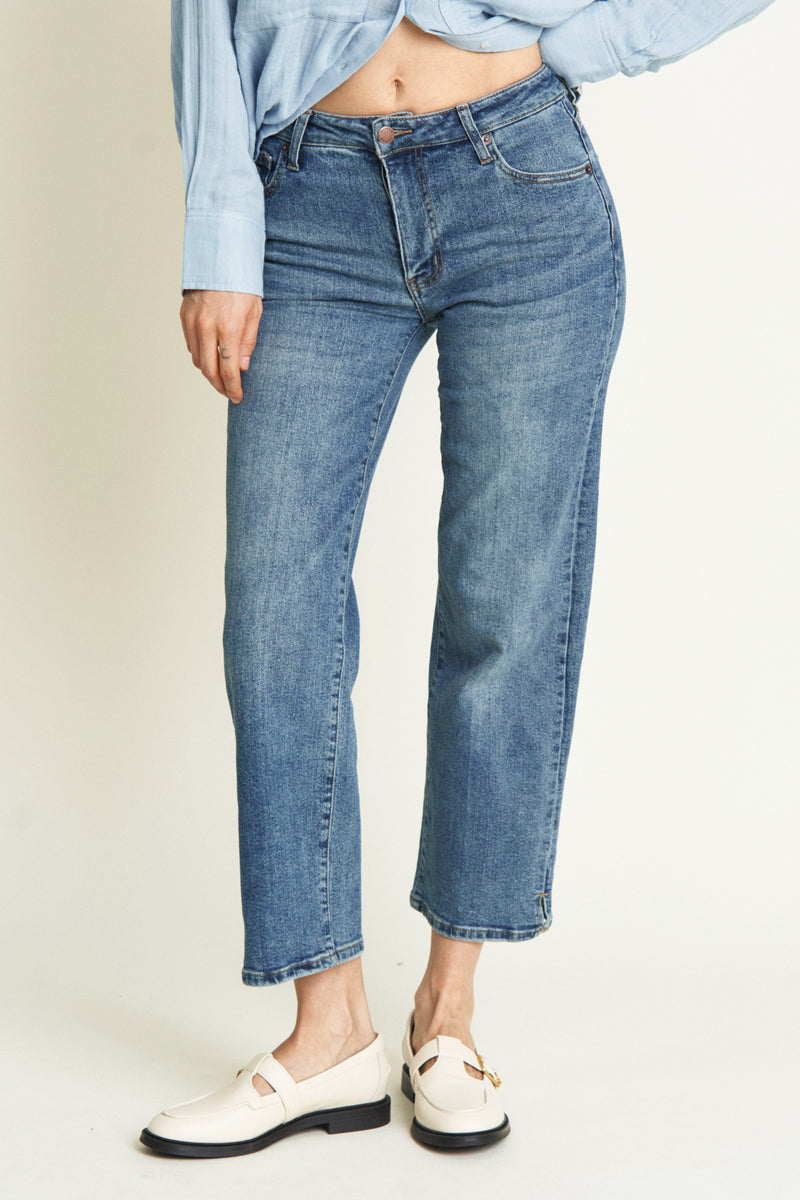 Full front view of the model wearing high rise wide leg cropped jeans. The jeans provide a flattering fit with a structured, cropped silhouette.