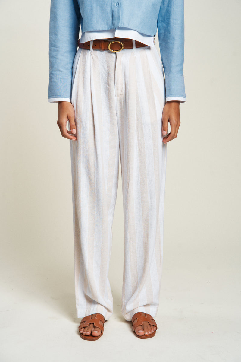 Close-up of lightweight high-waisted dress pants with side pockets, worn with a white shirt and belt for a polished look.