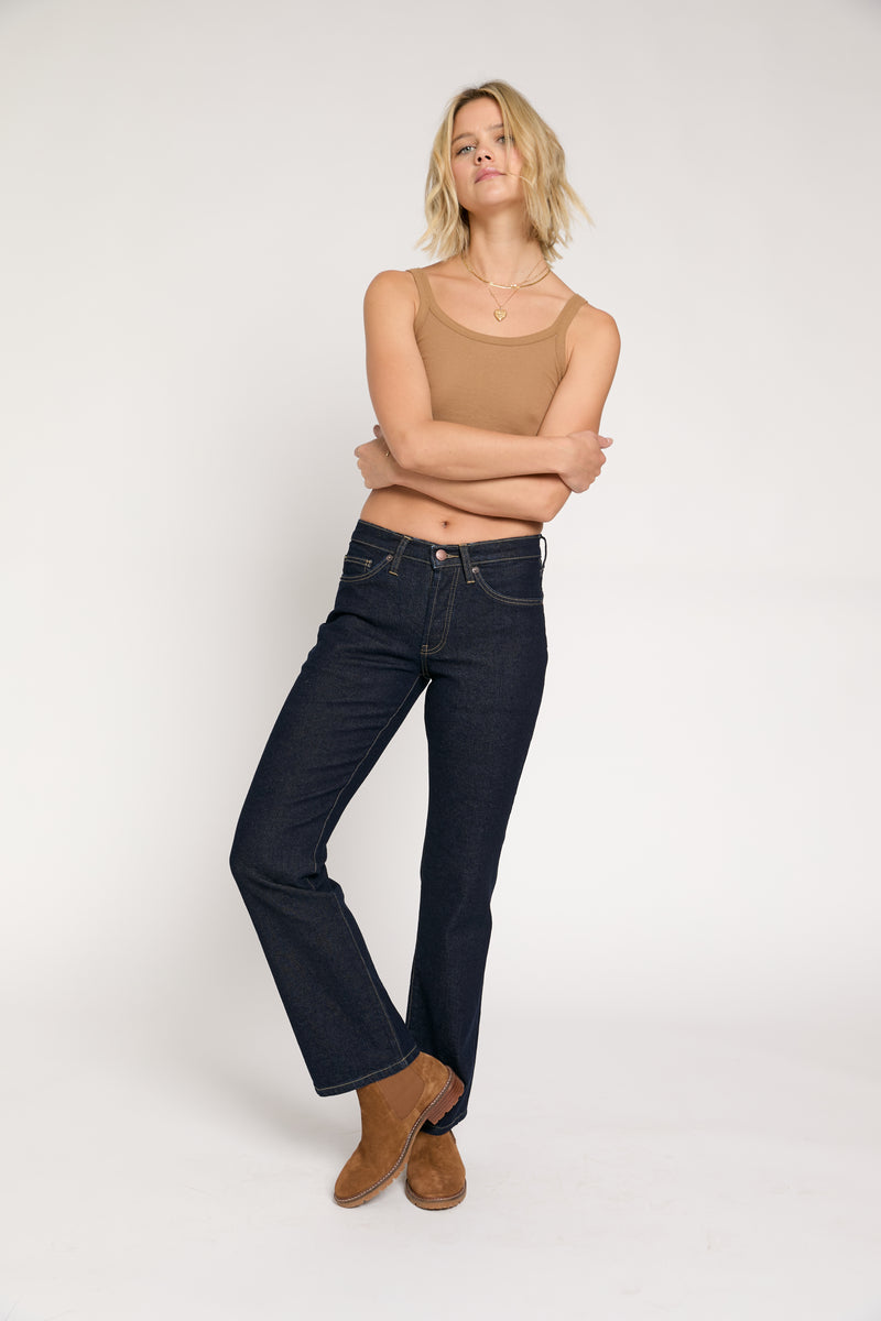 Close-up shot of the front of the jeans, focusing on the high-rise waistband and structured fit of these vintage-look jeans.