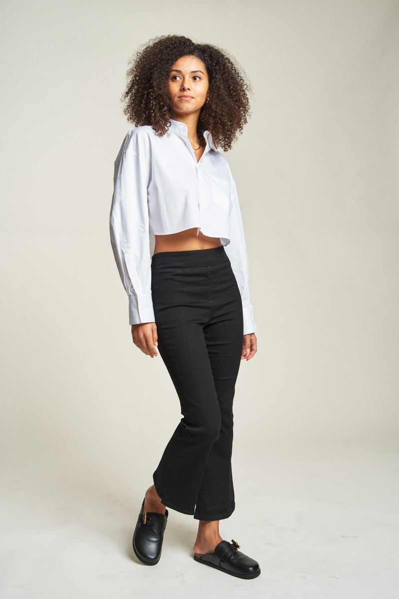 Side view of cropped flare pull-on pants, showing relaxed fit at the legs and cropped flare design at the hem.