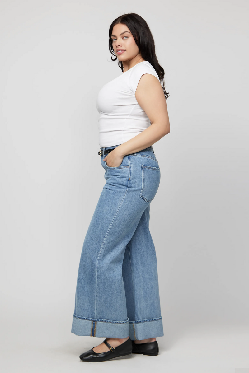 Side angle of mid-rise wide-leg cuffed jeans for women in soft light denim, plus-size fit.