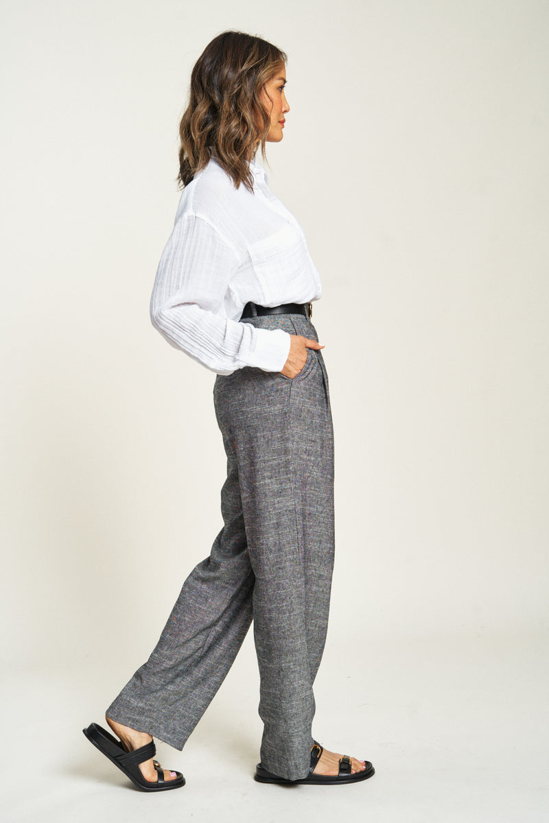 Side view of pleated high-waisted dress pants. These versatile lightweight trousers offer style and breathability.