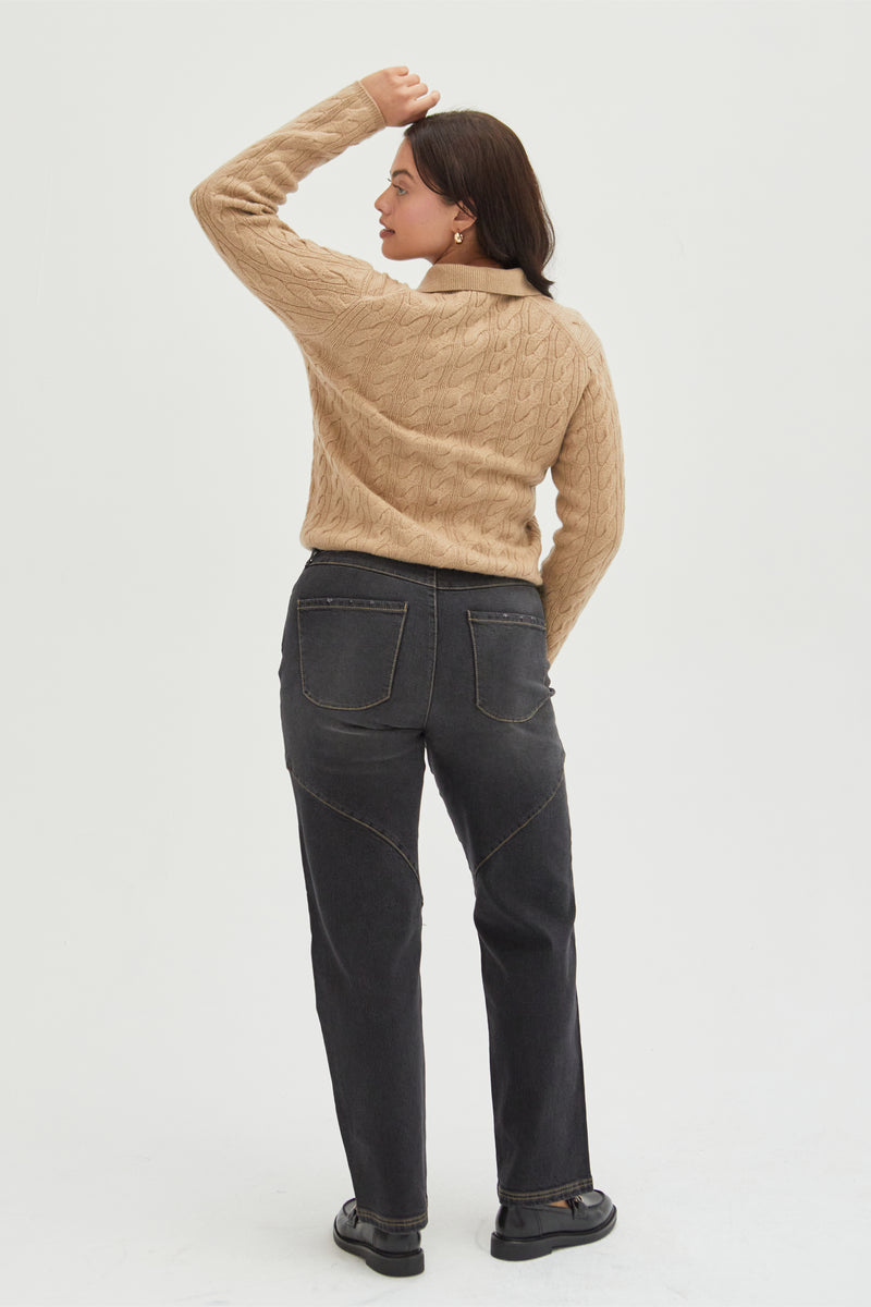 Back view of a plus-size model in dark-wash high-rise straight leg jeans, showcasing the structured fit and sustainable denim craftsmanship.