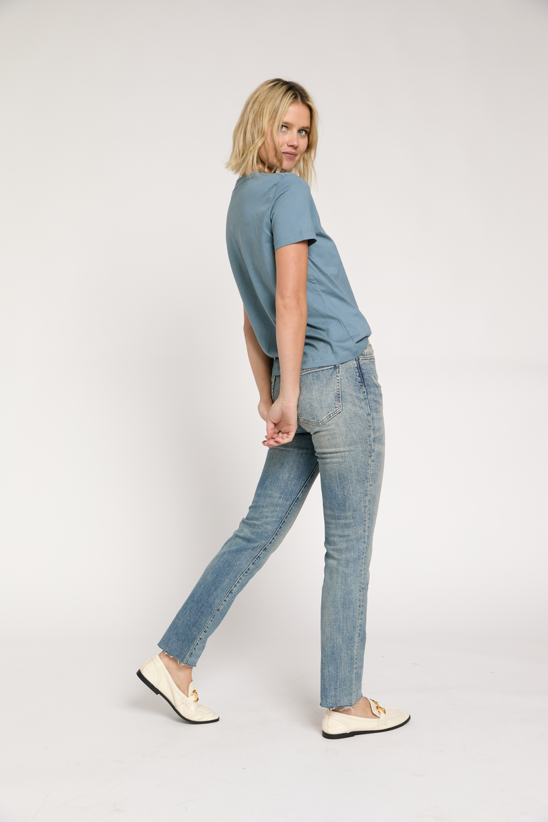 Side profile of model in vintage-inspired high rise jeans, showing off the straight leg and durable denim.