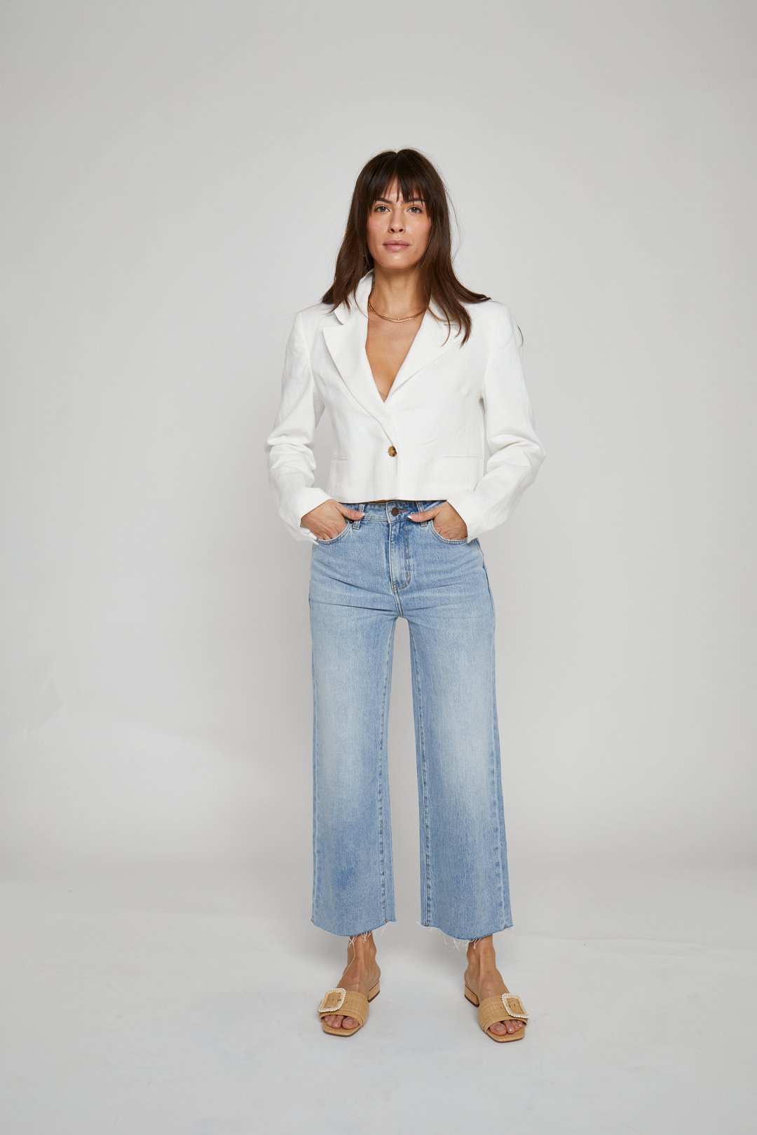 Front view of women's high-rise ankle cropped jeans in sustainable denim, featuring a deep blue wash, straight leg fit, and versatile everyday style.
