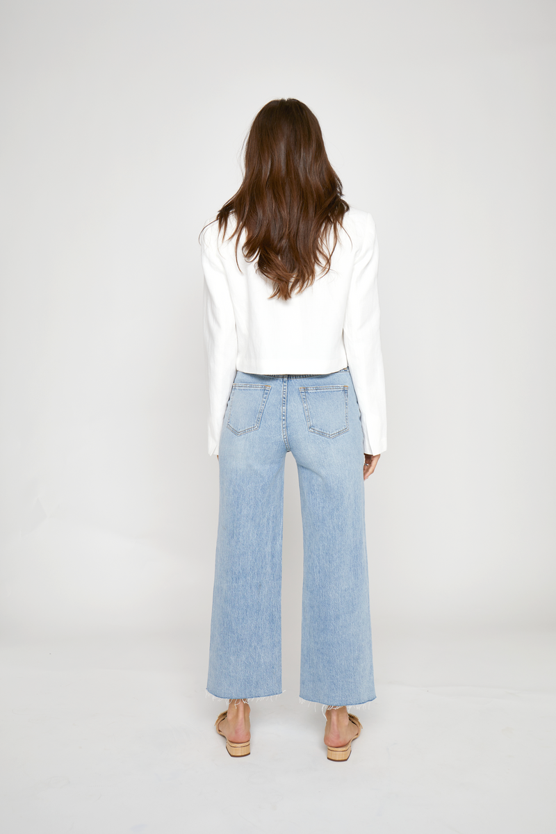 Back view of high-rise ankle crop jeans for women, highlighting structured pockets, eco-friendly denim material, and a flattering relaxed fit.