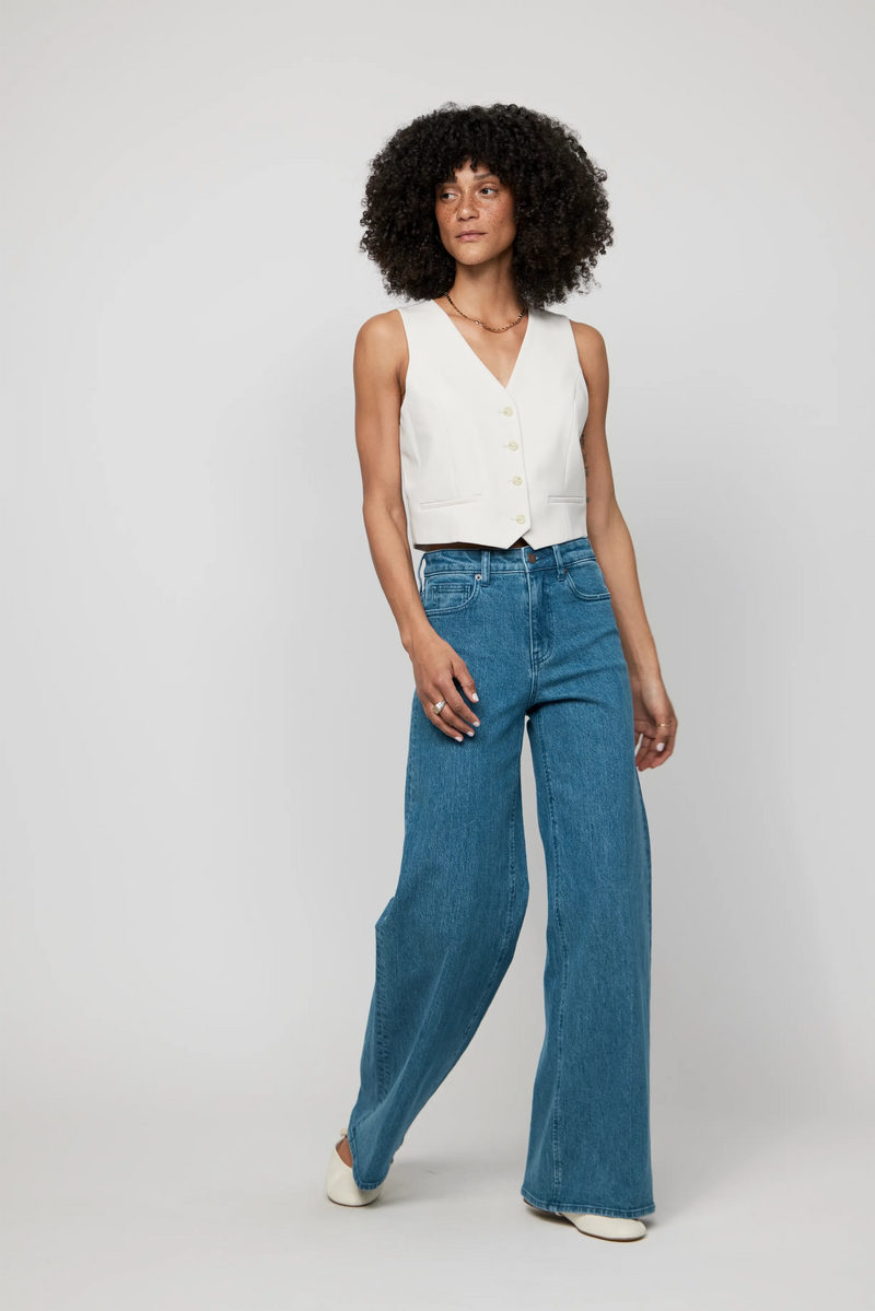 Video of model walking in high-rise wide-leg jeans in vintage-inspired blue wash, showcasing drape and everyday movement.