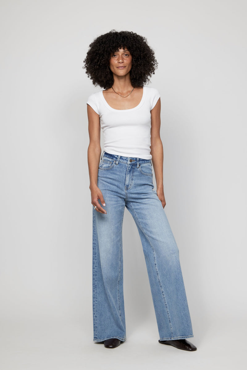 Video of woman walking in high-rise wide-leg denim showing natural movement and full length fit.