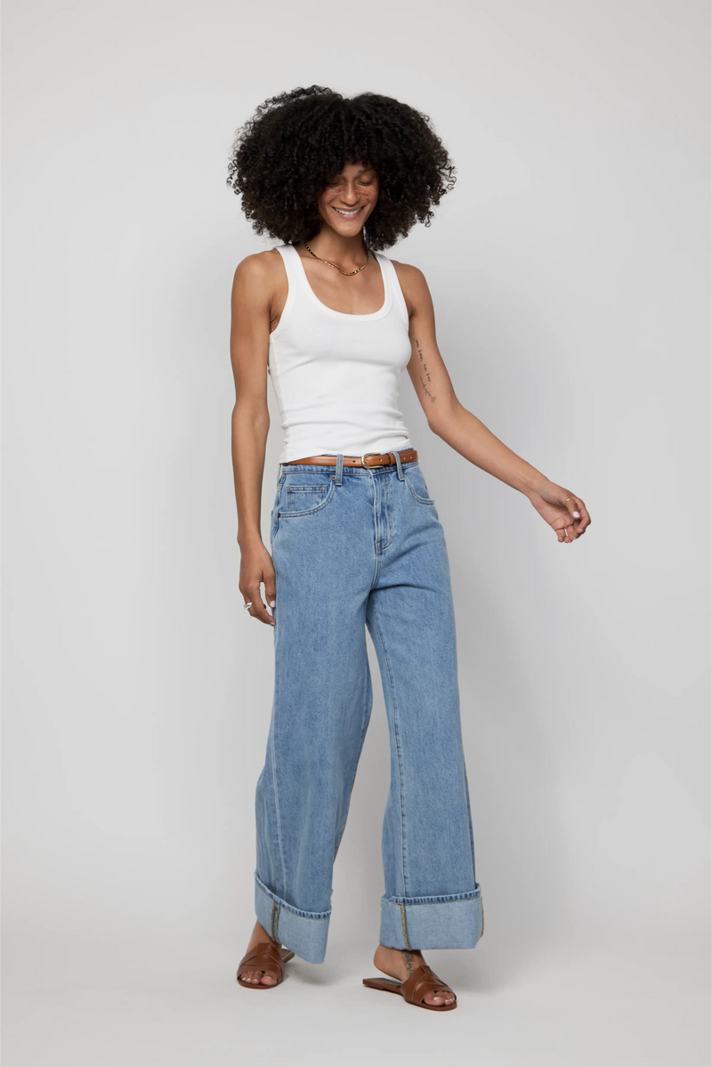 Video of model walking in mid-rise cuffed wide-leg jeans in light blue denim.
