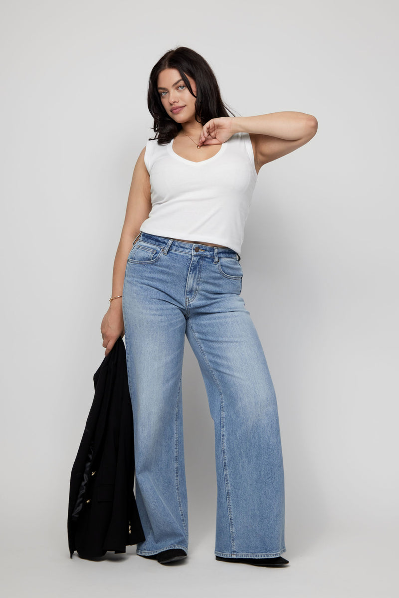 Video of model wearing high-rise wide-leg jeans, walking to highlight drape and soft stretch fit.