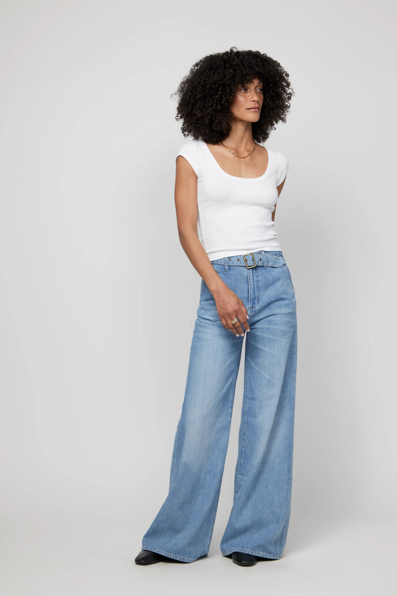 Video of woman in high-rise wide-leg jeans, walking to show the flow, fit, and movement of this statement silhouette.