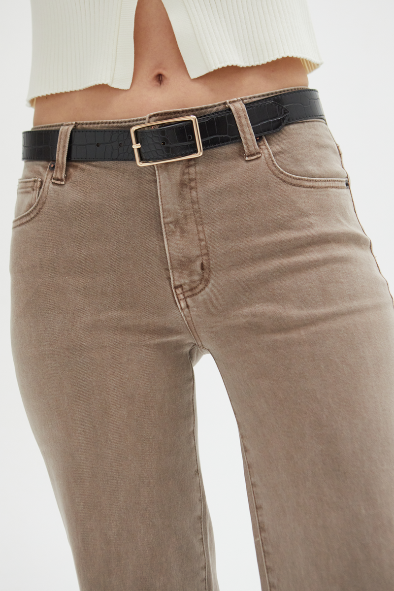 Model moving in brown wide-leg ankle crop jeans, demonstrating their comfort and effortless everyday wearability.