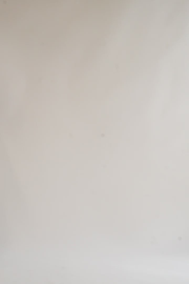 Video of model showcasing lightweight high-waisted dress pants paired with a white shirt in motion, highlighting flowy fabric.