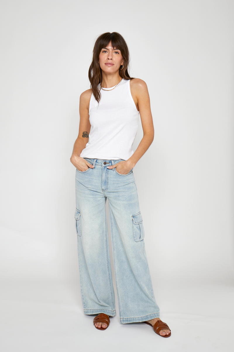 Wide-leg cargo jeans with oversized pockets in light wash denim, front view showing the relaxed fit and sustainable design.