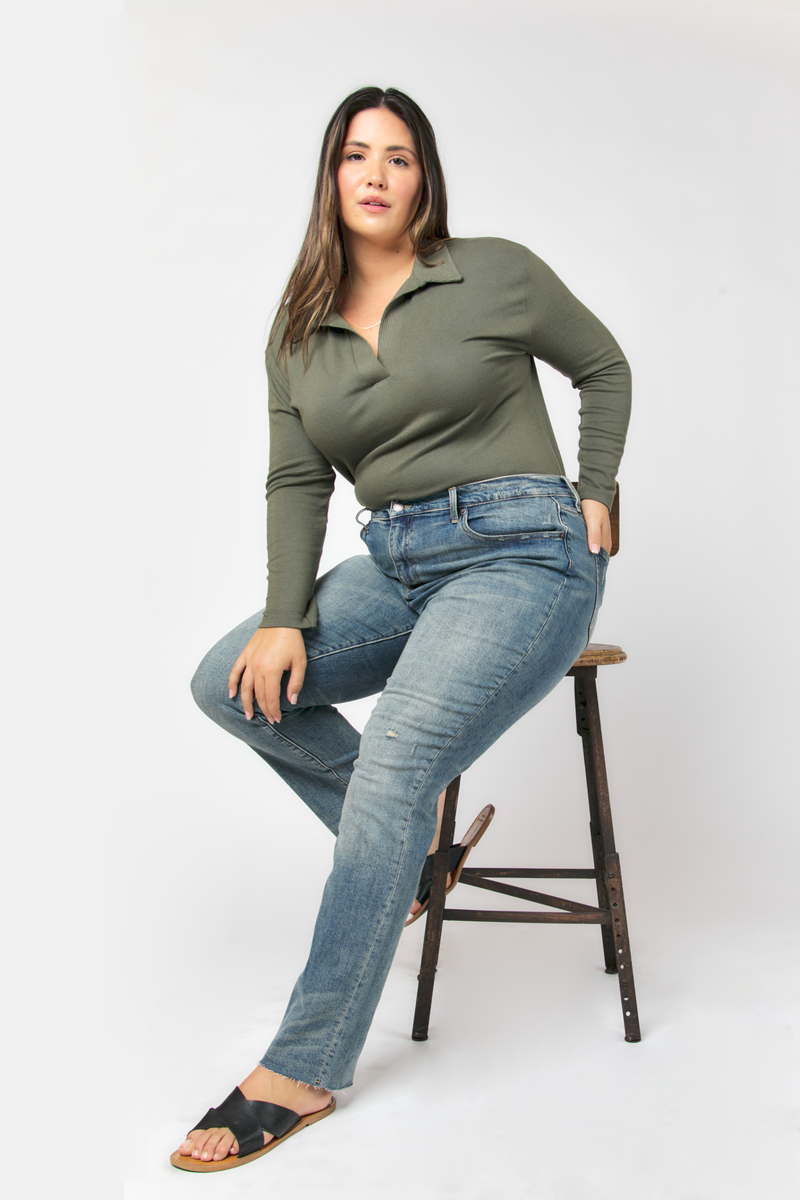 Model styled in high rise straight leg jeans, classic blue wash, paired with a white tee, front view showing a sleek and casual fit.