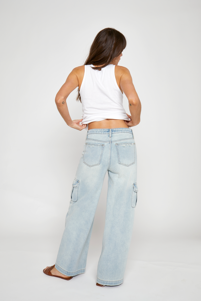 Light wash cargo jeans with practical pockets, back view showcasing the comfortable, high-rise fit and sustainable materials.