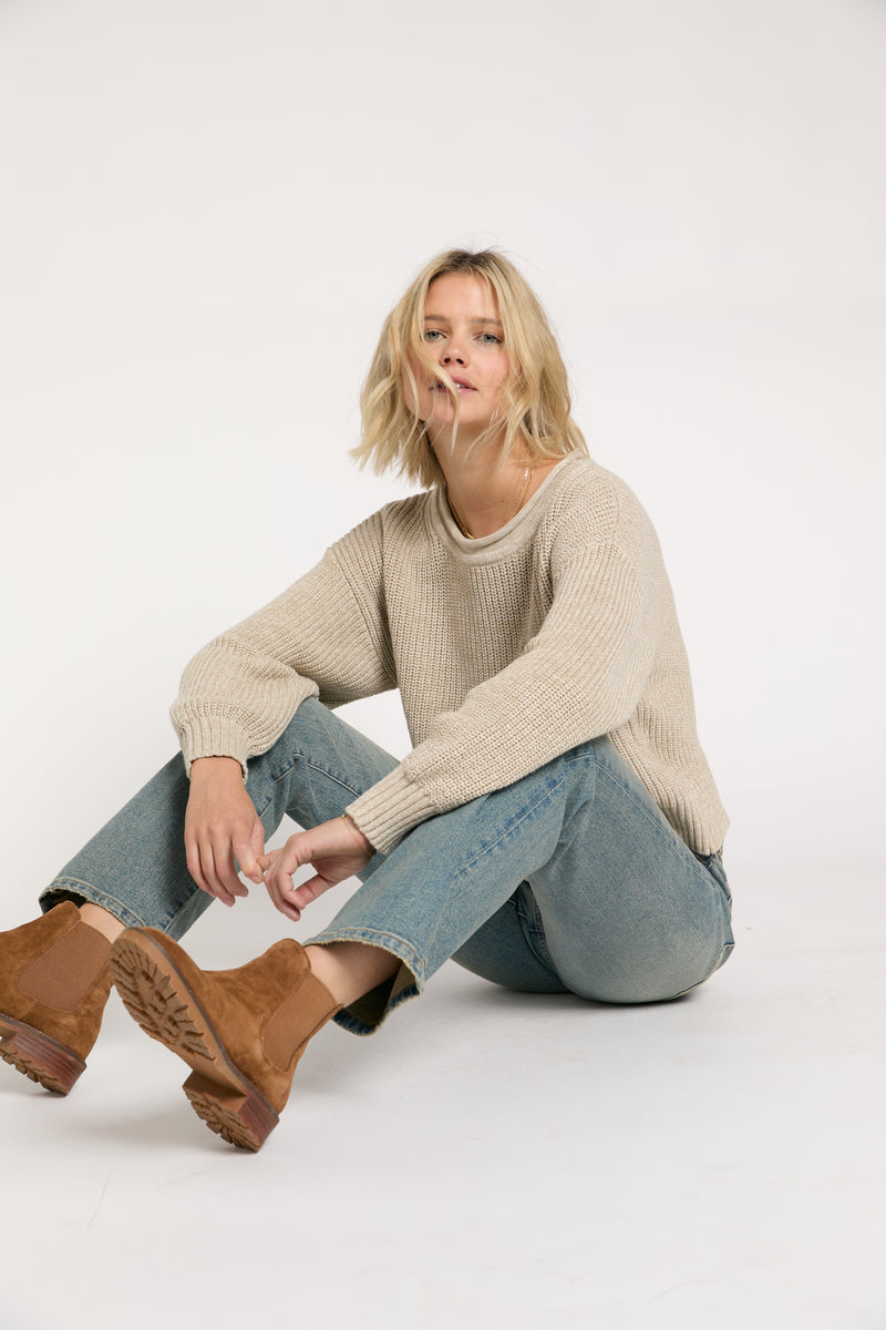 Close-up of light vintage wash mid-rise straight-leg jeans, showing the faded detailing and relaxed fit.