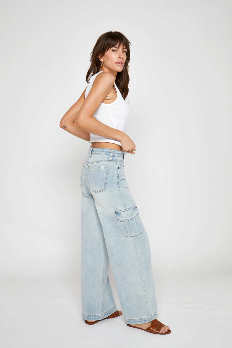 Cargo denim with light wash, side view featuring wide-leg cut, eco-friendly materials, and laid-back fit for everyday wear.