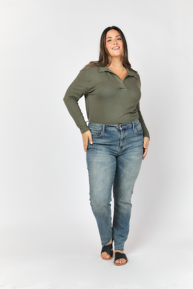 Model standing confidently in classic blue high rise jeans, paired with a white t-shirt, highlighting the straight leg silhouette.