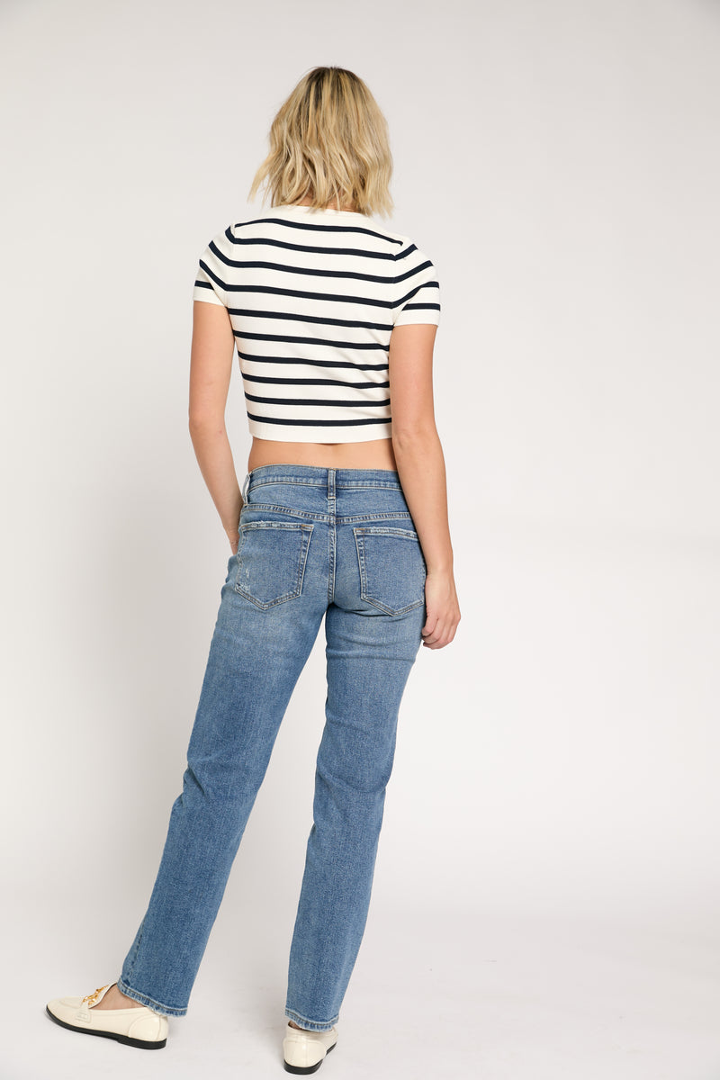 Back view of low-rise straight leg jeans in sustainable light wash denim, highlighting structured pockets, a flattering fit, and a modern casual aesthetic.