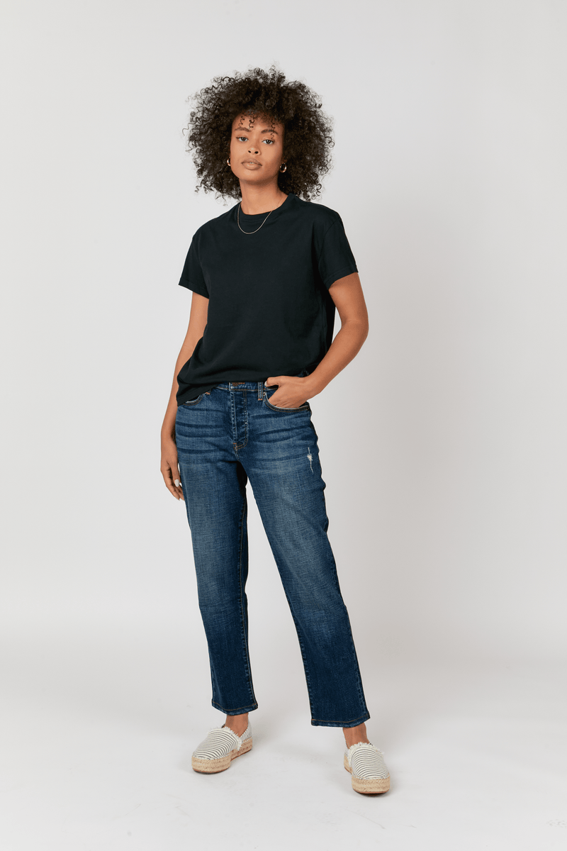 Front view of a model wearing straight leg jeans in dark vintage wash. The relaxed fit straight leg denim features a mid-rise waist for comfort and ease.