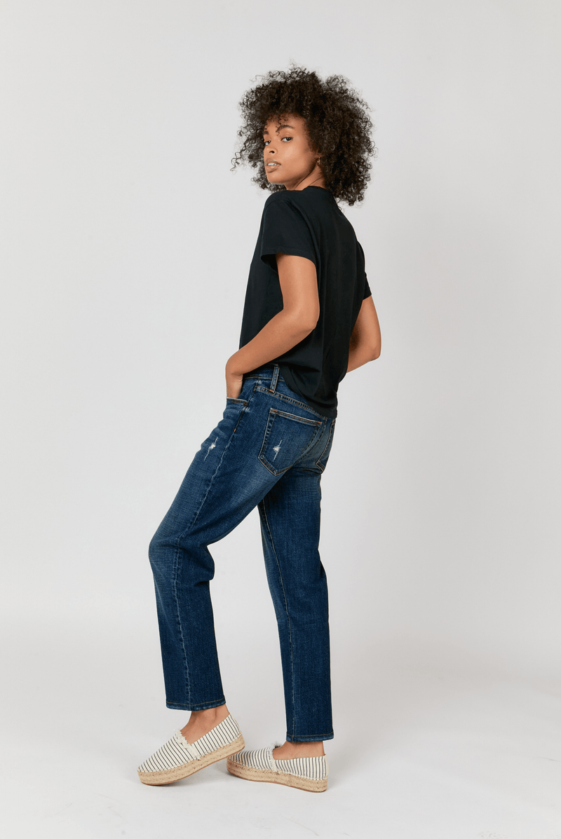 Model wearing mid-rise straight leg jeans, showing the structured fit through the hips and thighs with a relaxed straight-leg design.