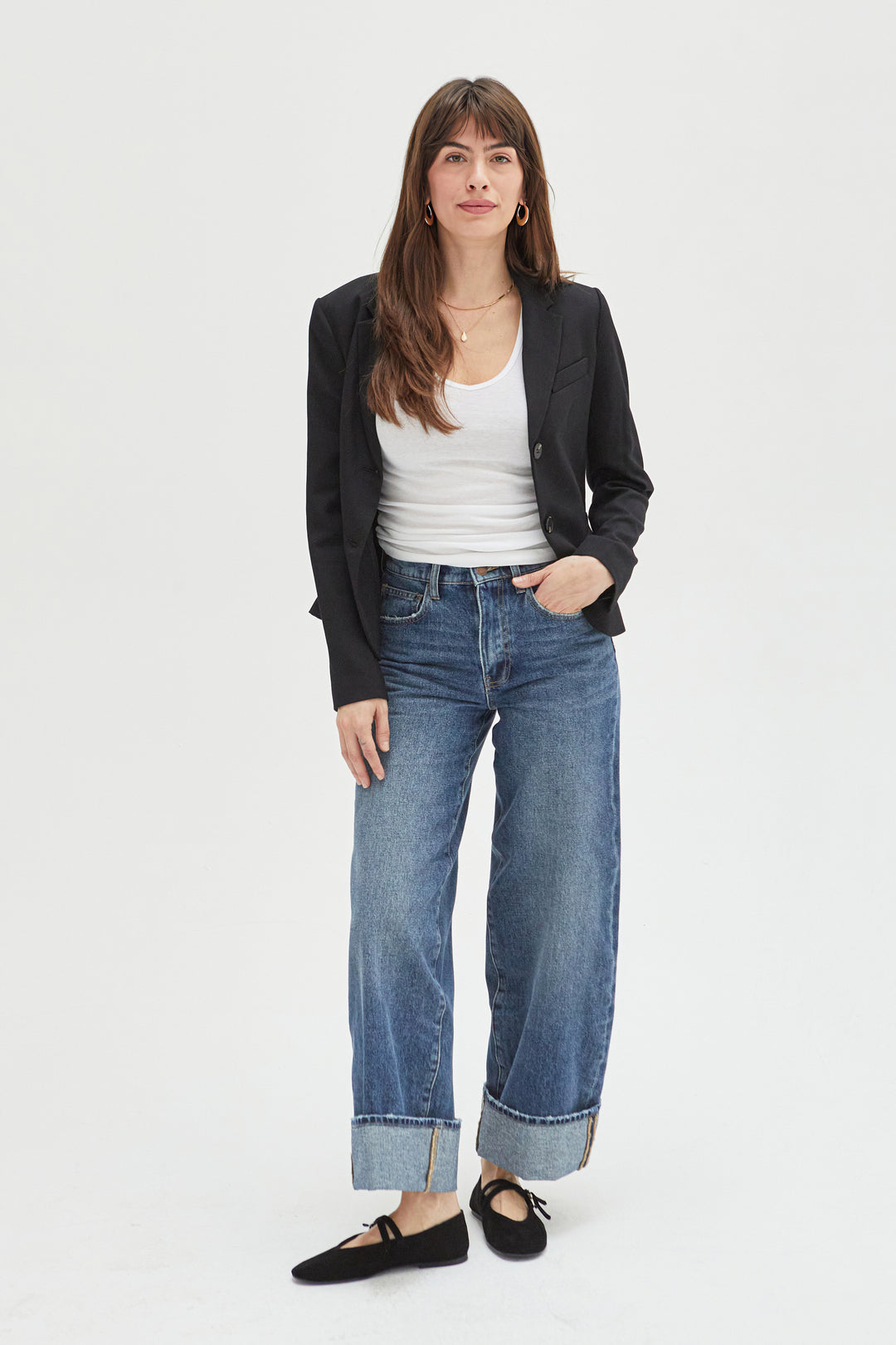 Front view of women's mid-rise wide-leg jeans in sustainable denim, featuring a relaxed fit, cuffed hem, and classic blue wash for an effortless look.