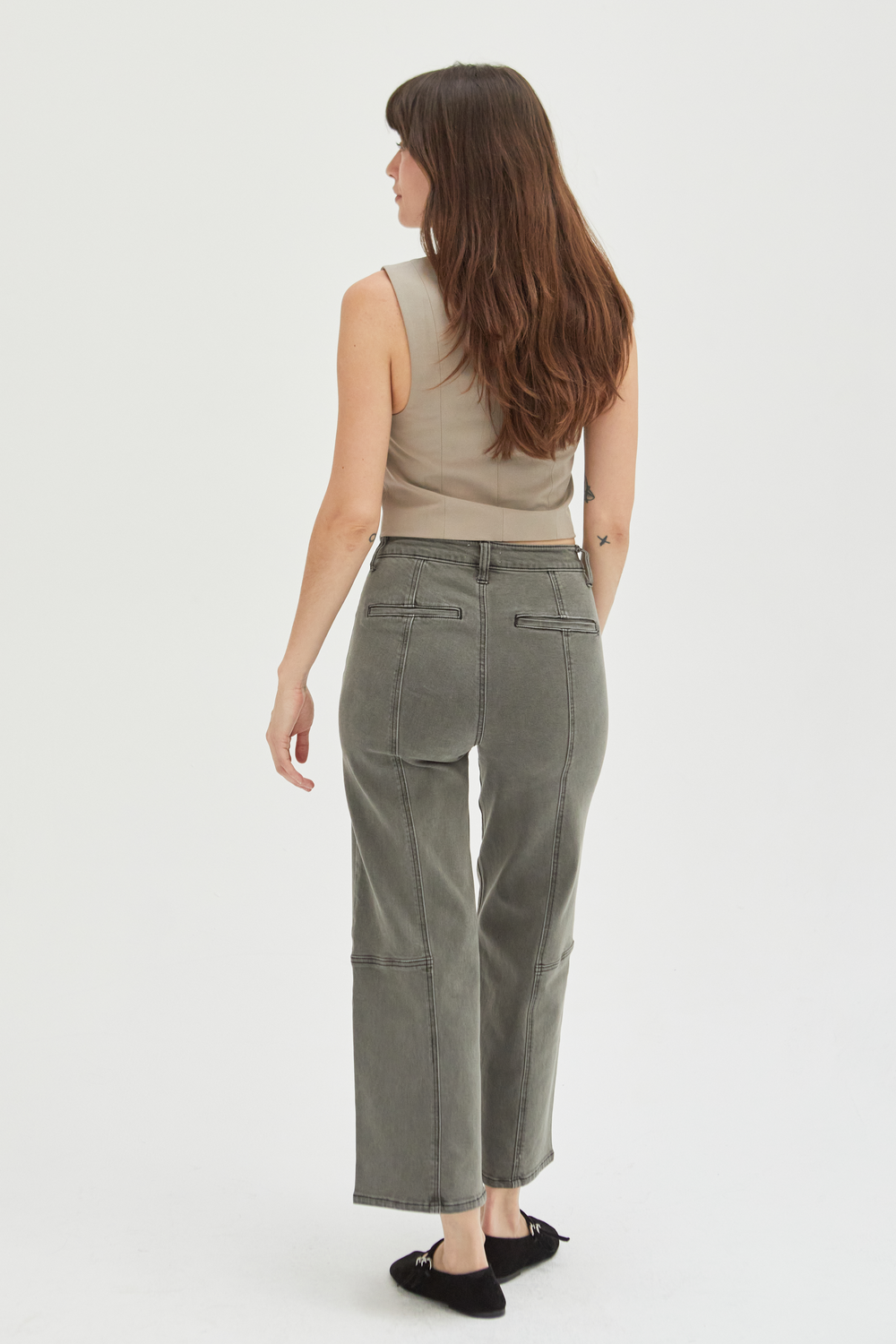 Back view of a model in olive wide-leg ankle crop jeans, highlighting the clean lines and tailored fit.