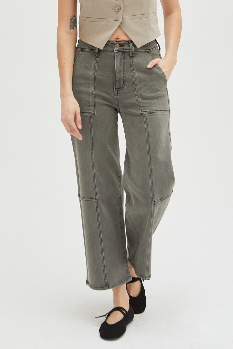 Close-up of olive wide-leg ankle crop jeans, emphasizing the durable denim construction and unique stitching details.
