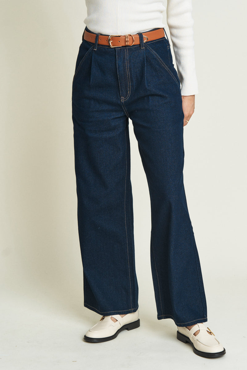 Close-up of dark blue low-rise baggy jeans, emphasizing the super relaxed fit and soft, durable denim fabric.
