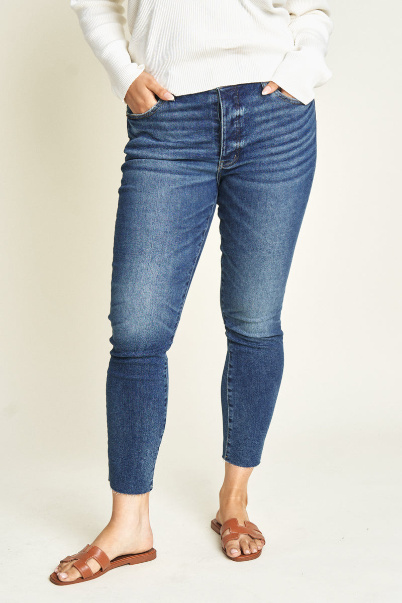 Close-up of dark wash high rise skinny jeans, emphasizing the flattering fit.