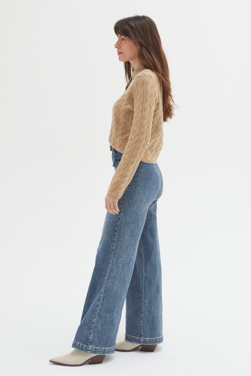 Side view of a model in high-rise wide-leg jeans, paired with a cozy sweater and boots, showcasing their timeless and versatile appeal.