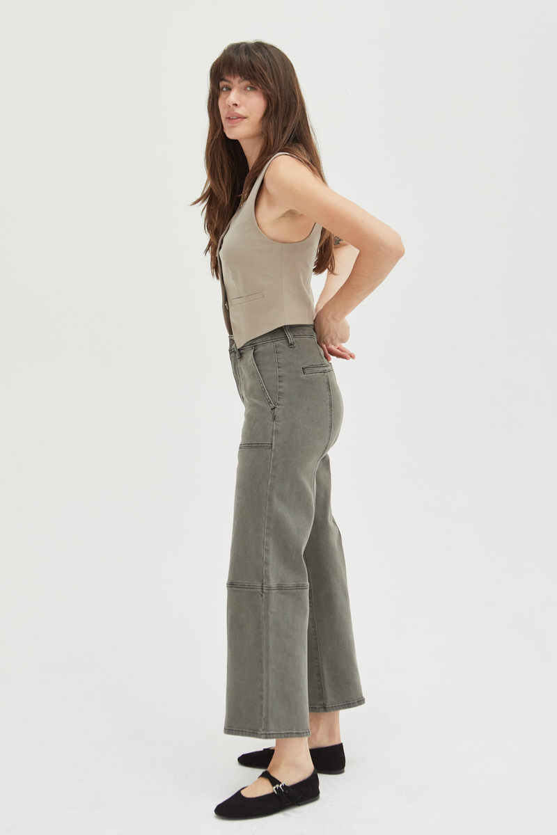 Side view of a model in olive wide-leg ankle crop jeans, paired with a neutral top, showcasing a chic and versatile silhouette.