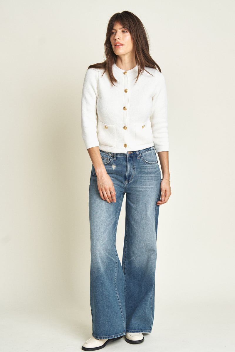 Model moving in mid-rise wide-leg jeans, demonstrating their comfortable fit and effortless flow for everyday wear.