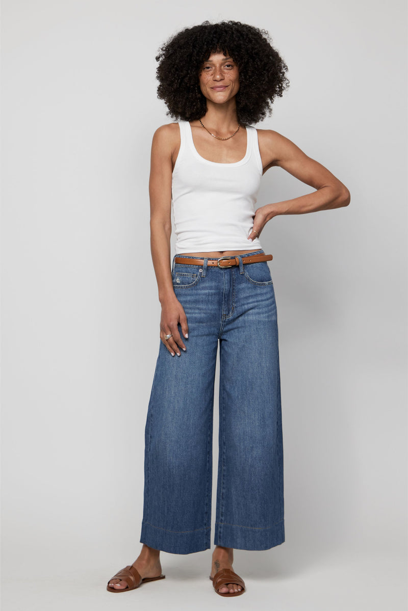Video of plus-size woman wearing high-rise cropped wide-leg jeans in a classic mid-blue denim wash.