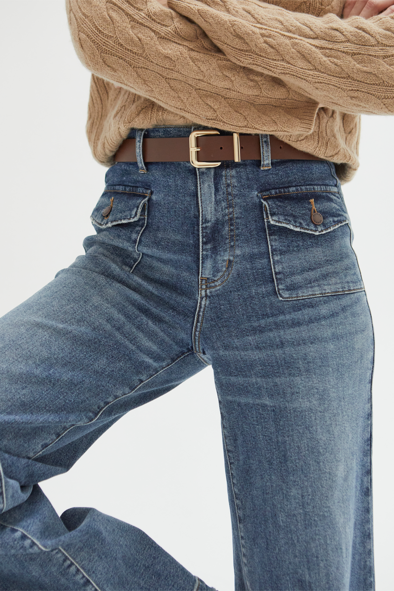 Model moving in medium blue high-rise wide-leg jeans, demonstrating their comfortable fit and effortless flow for all-day wear.